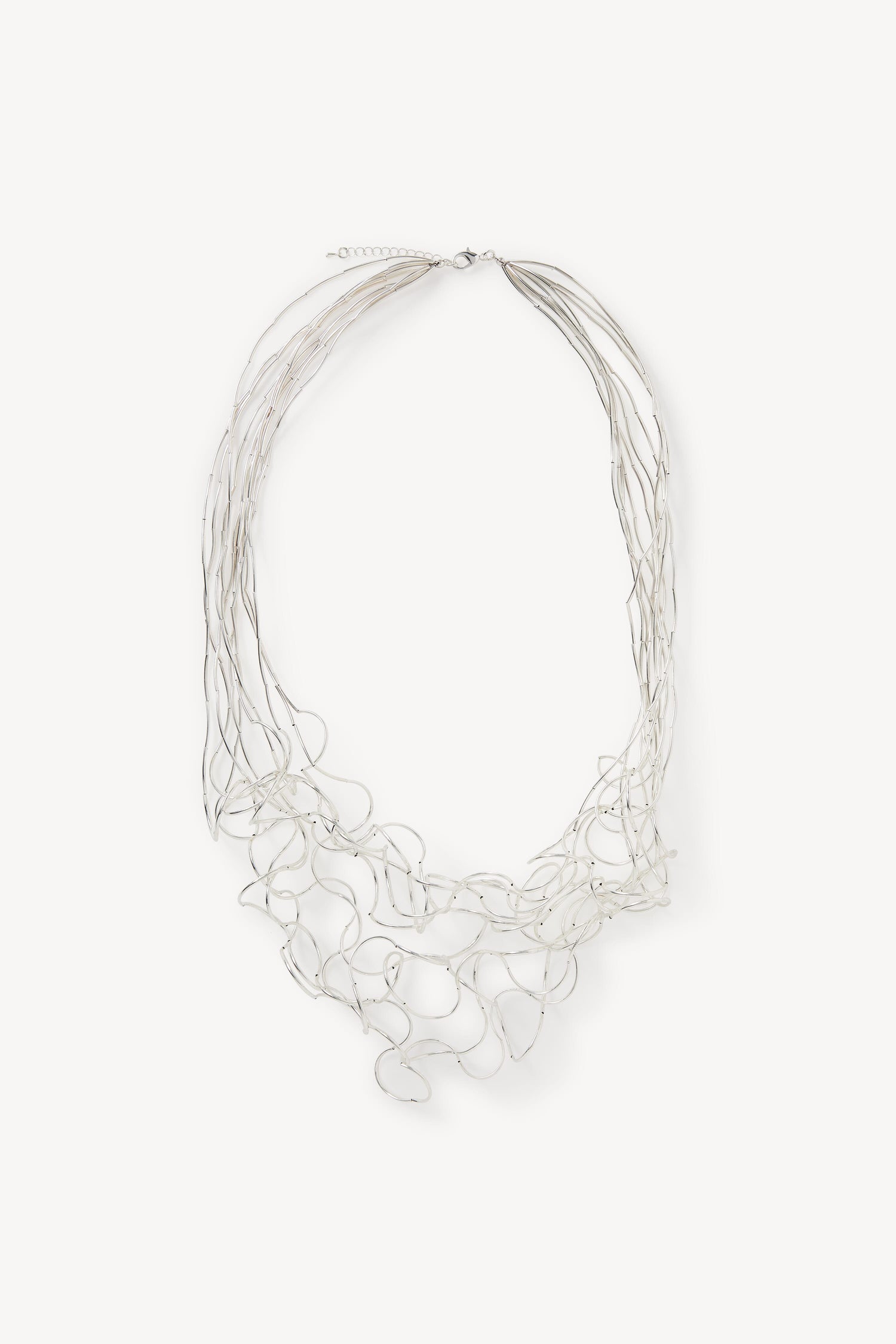 A Long Medley Necklace made of silver wires on a white background.