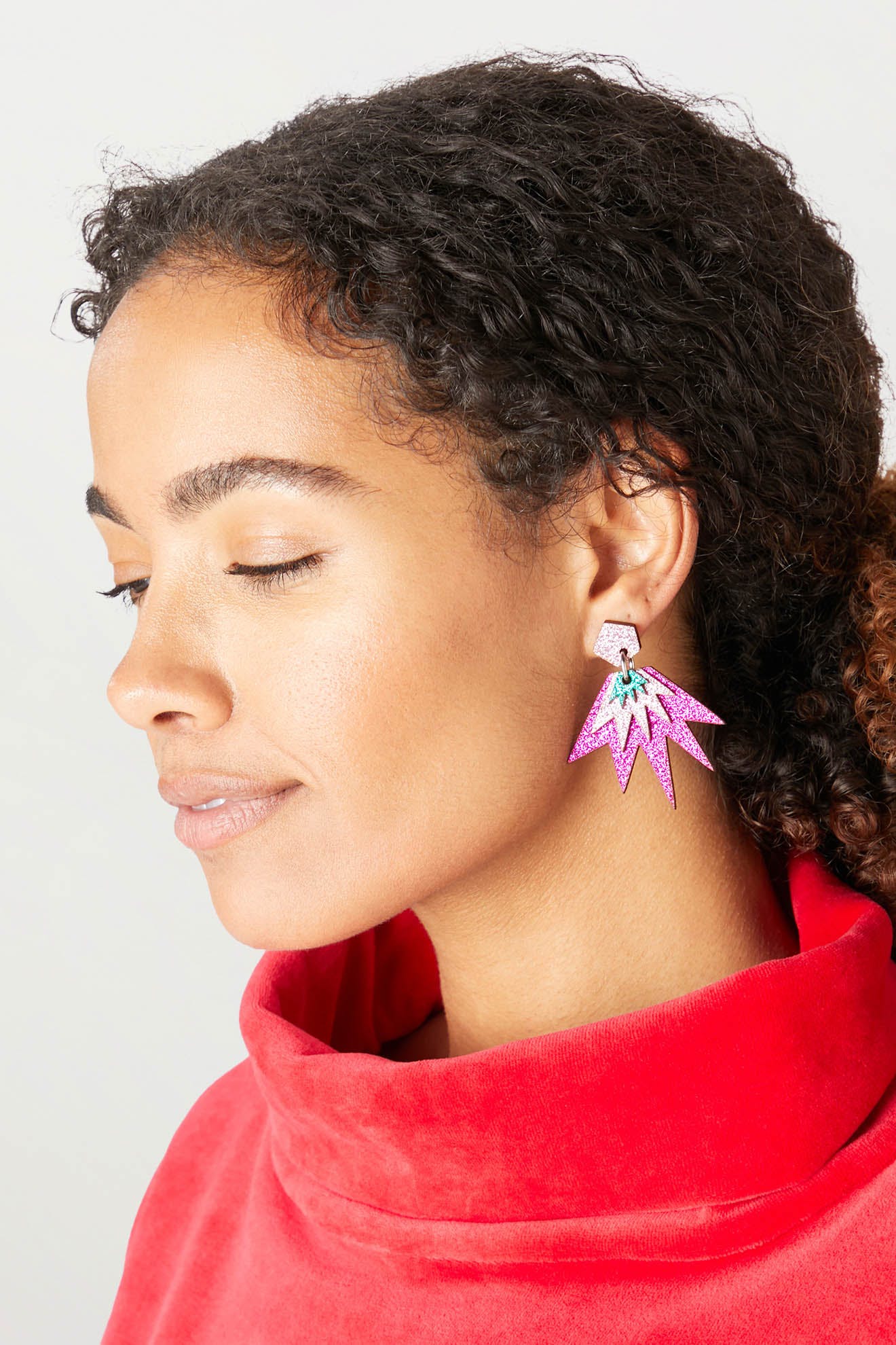 Woman with closed eyes wearing a red turtleneck and large, colorful, geometric-shaped Sparkle Drop Earrings.