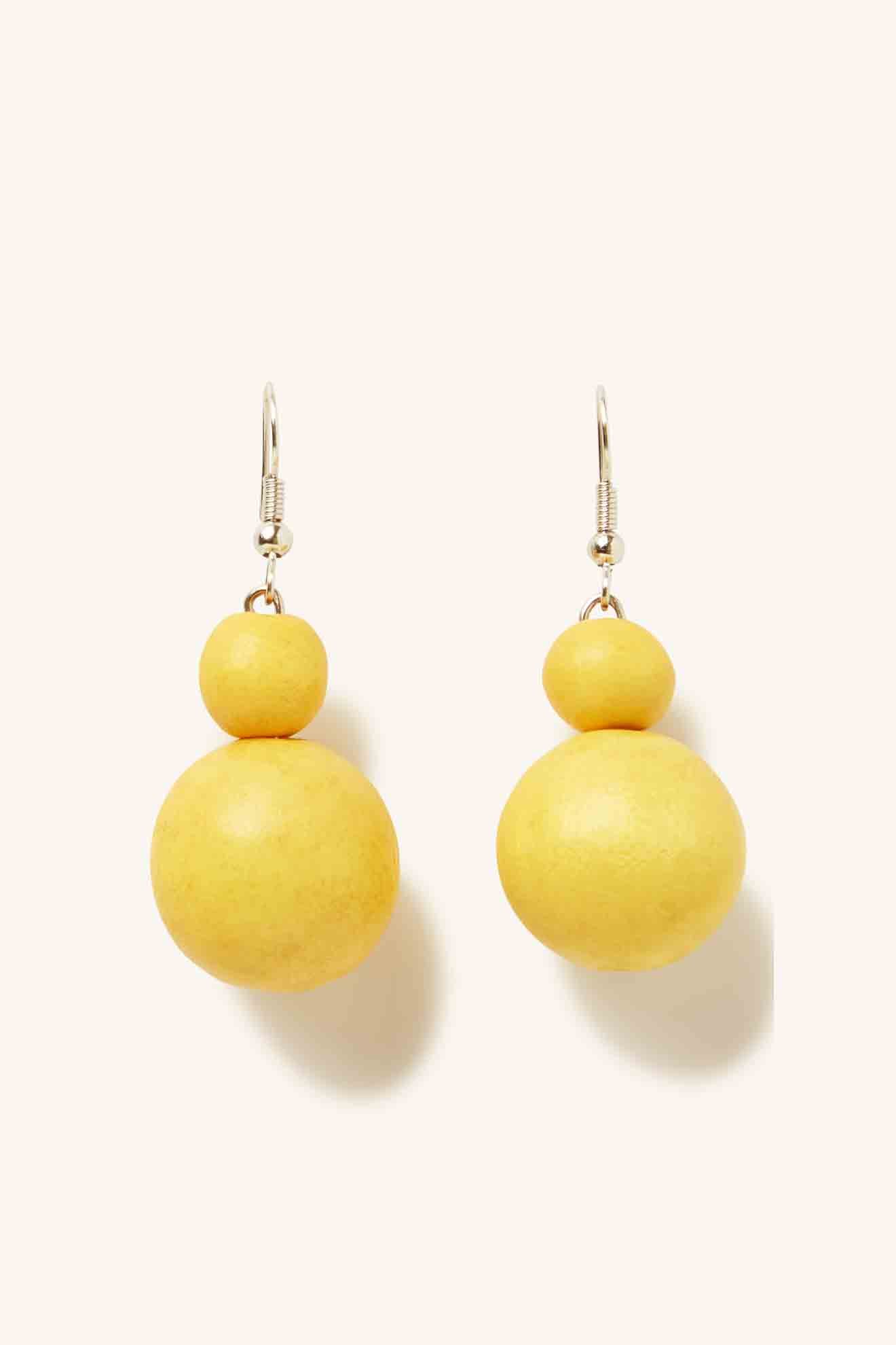 A pair of Double Sphere Earrings featuring wooden beads on a white background.