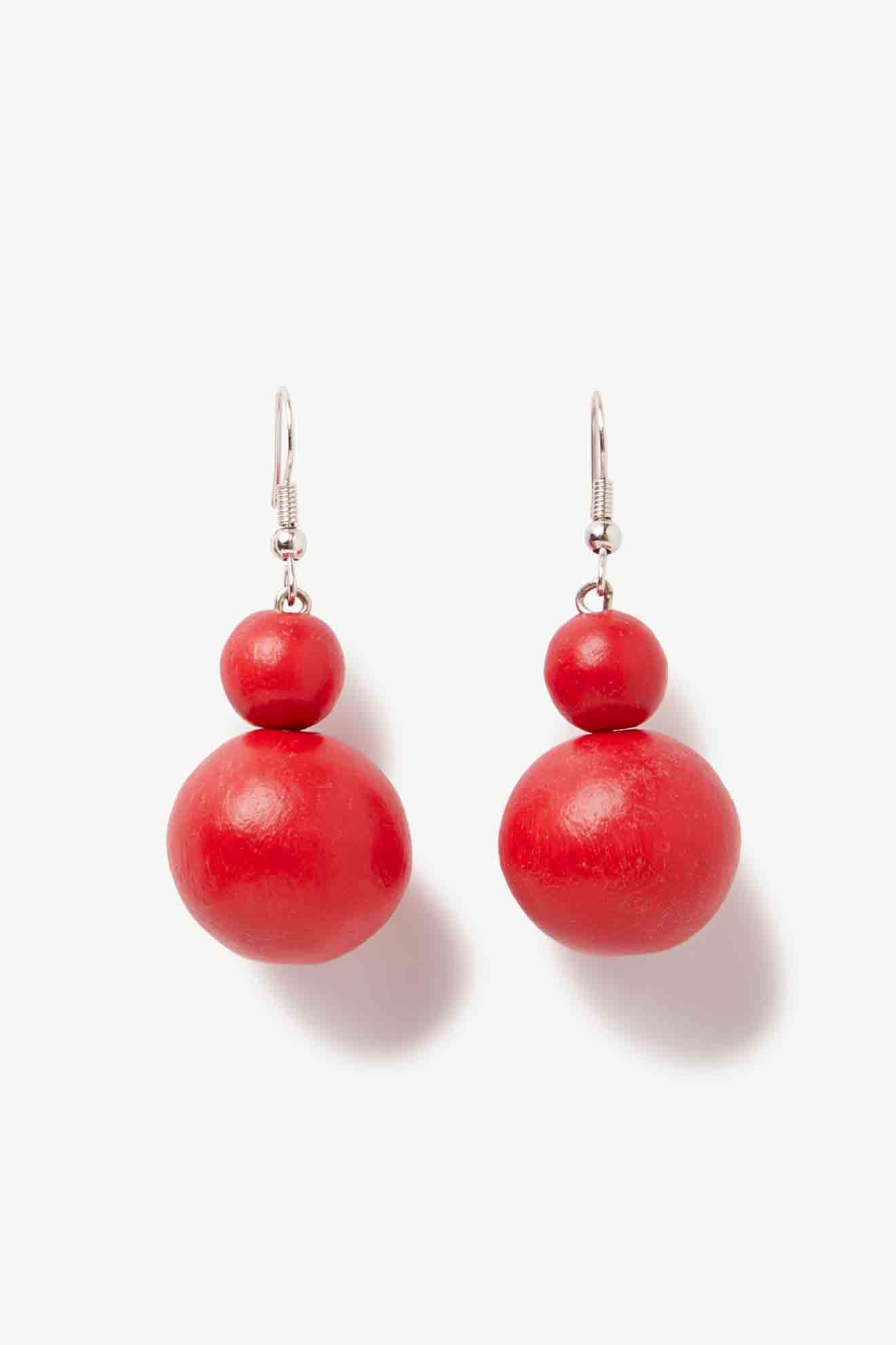 A pair of red wooden Double Sphere Earrings from a jewellery brand on a white background.
