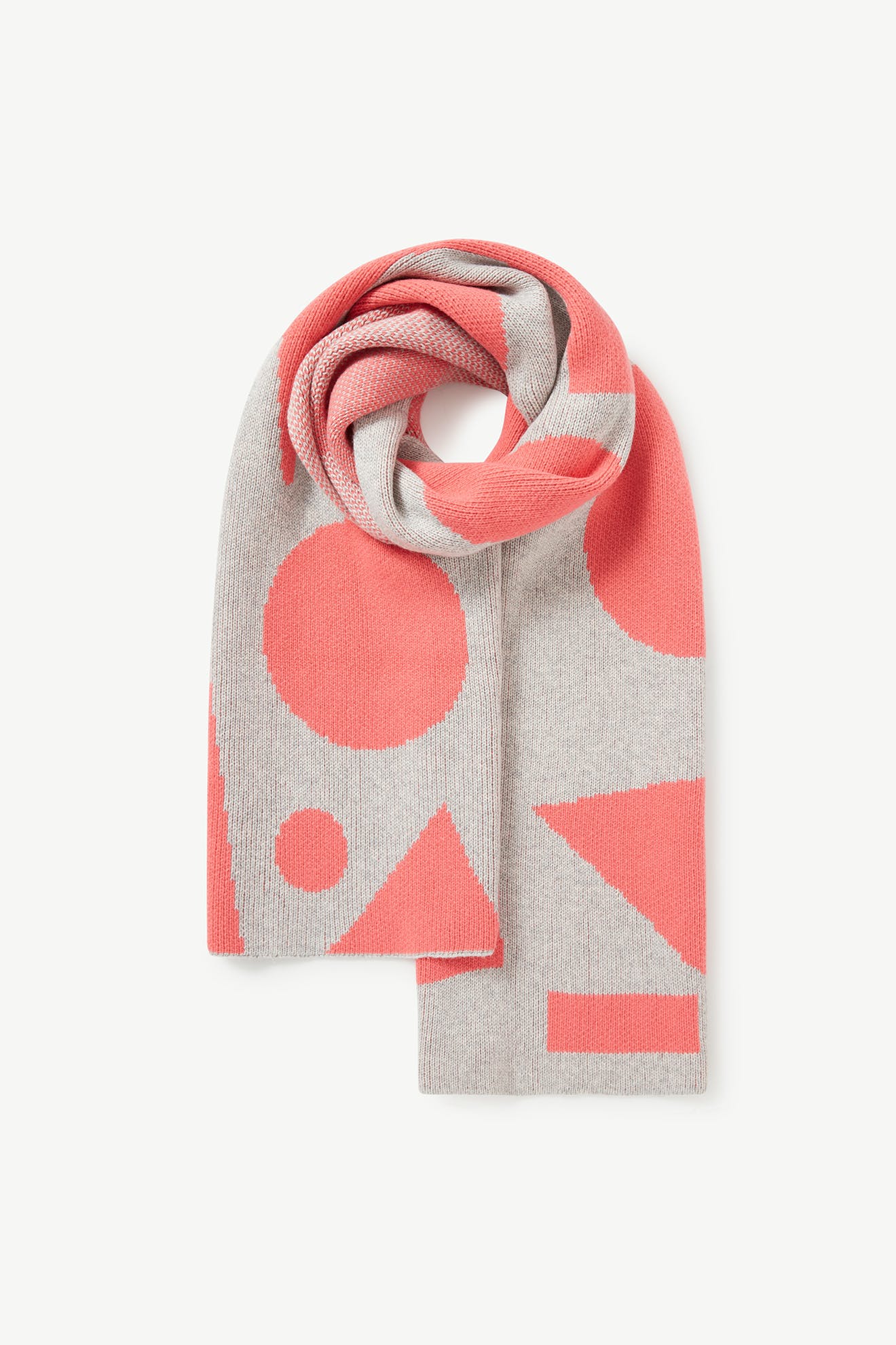 The Recycled Wool Allsorts Scarf features a rolled-up design with geometric shapes in pink and gray, crafted from recycled vegan materials in a family-run factory.