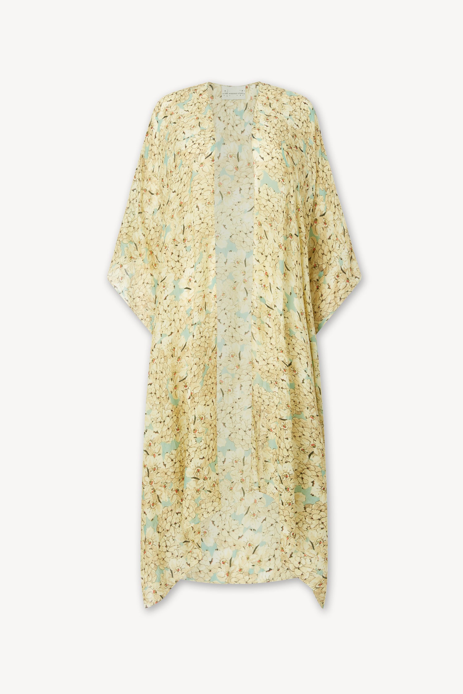 The Blossom Blue Throwover by One Hundred Stars is a loose-fitting, short-sleeve kimono-style garment featuring a light yellow and beige floral pattern on white—perfect as a lightweight layer or beach coverup.