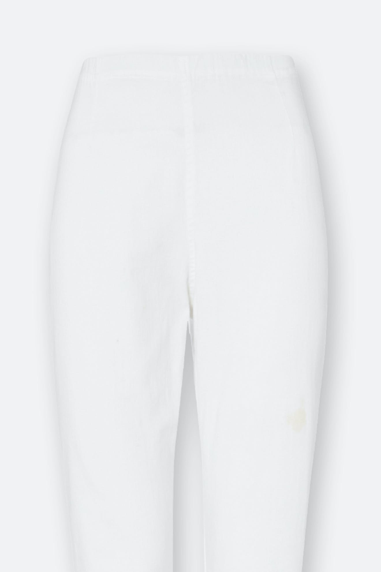 Stretch Cotton Twill Trouser in white shown from the front on a light background, featuring a slim-leg tapered fit and a faint stain on the right thigh.