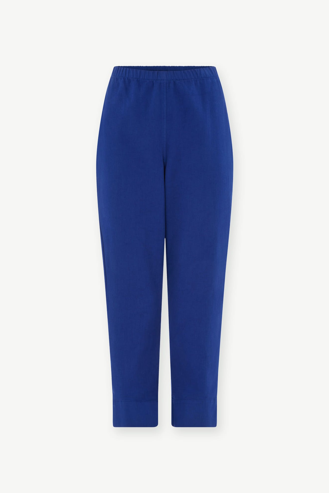 The SS22 Stretch Cotton Trouser in bright blue features a slim-leg tapered fit, elastic waistband, and is made from OEKO-TEX certified cotton, shown on a plain white background.