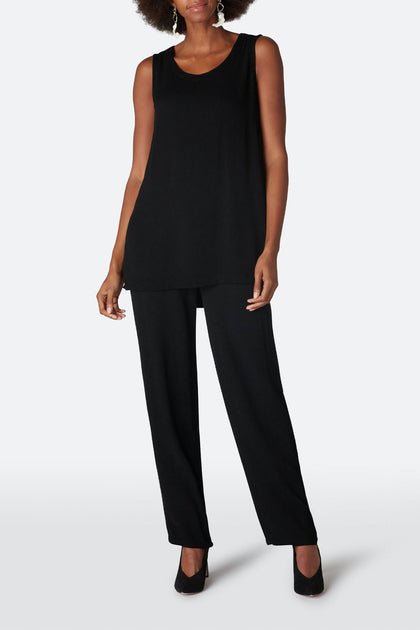 A person is wearing a Crepe Long Vest in black, paired with black wide-leg pants and black heels, standing against a light gray background.