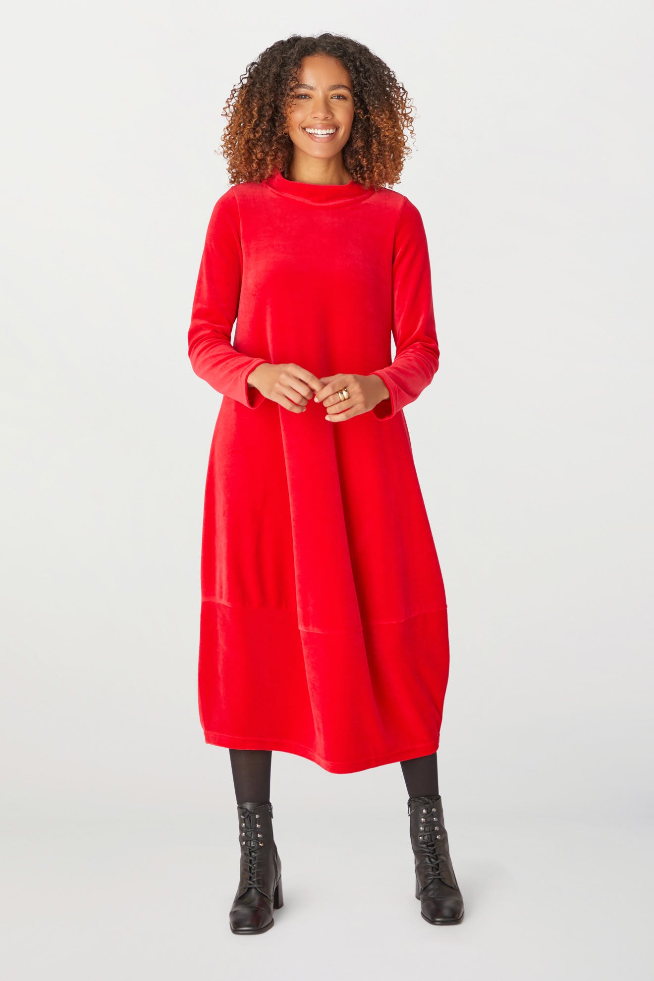 A woman elegantly dressed in a Velvet Jersey Bubble Dress, perfect for the holiday season.