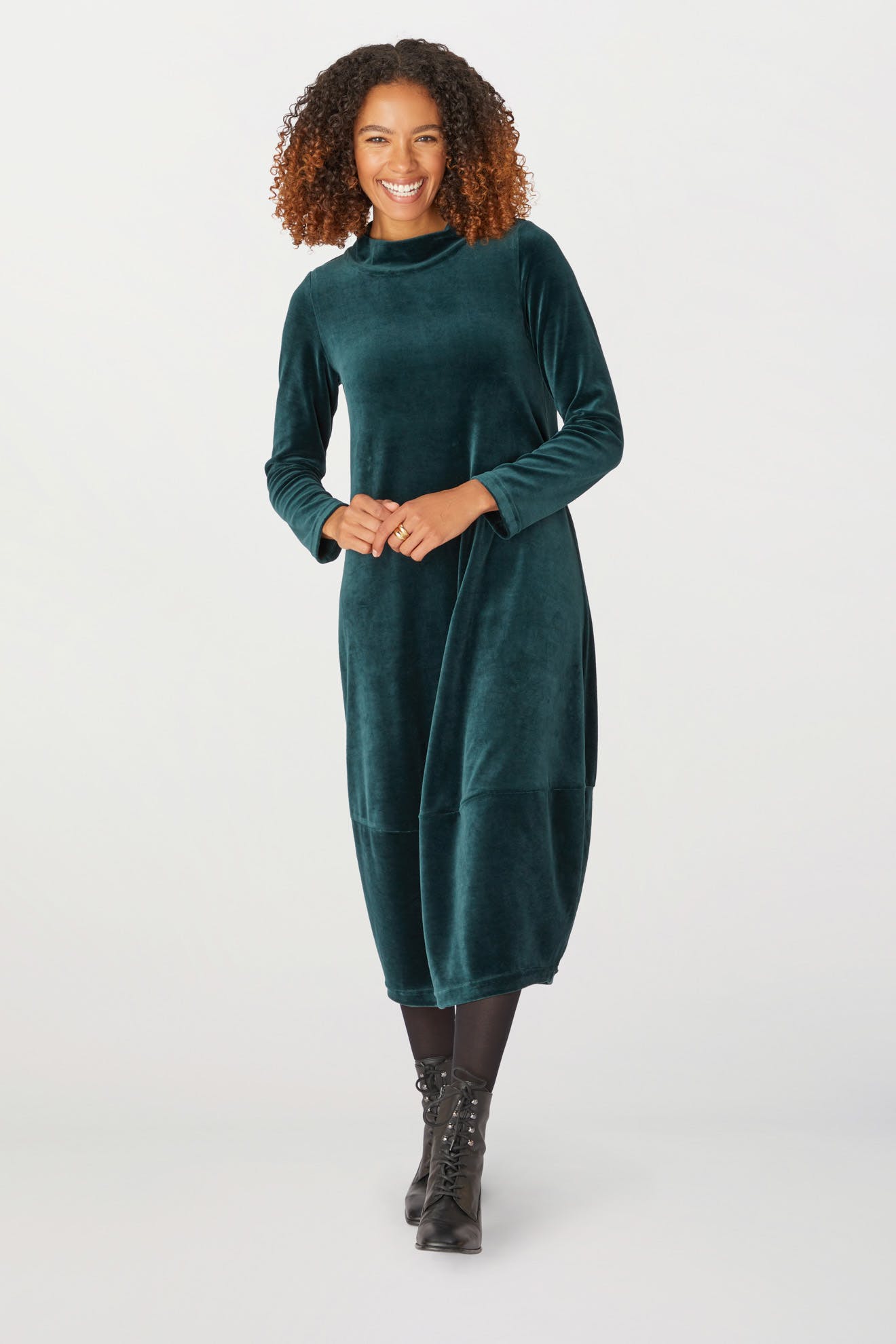 A woman wearing a Velvet Jersey Bubble Dress at a holiday season gathering.