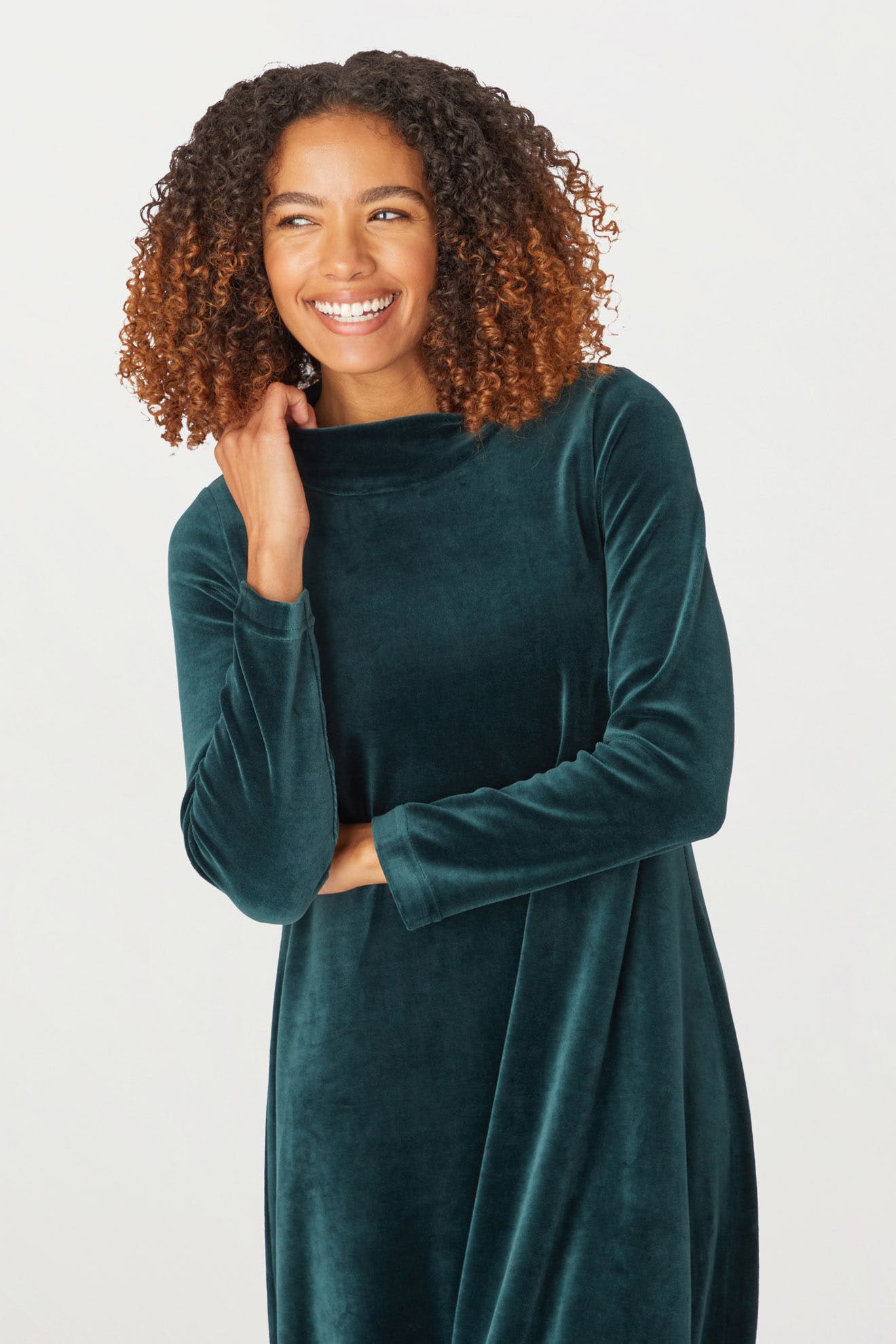 A woman wearing a Velvet Jersey Bubble Dress ideal for the holiday season, featuring a low turtleneck.