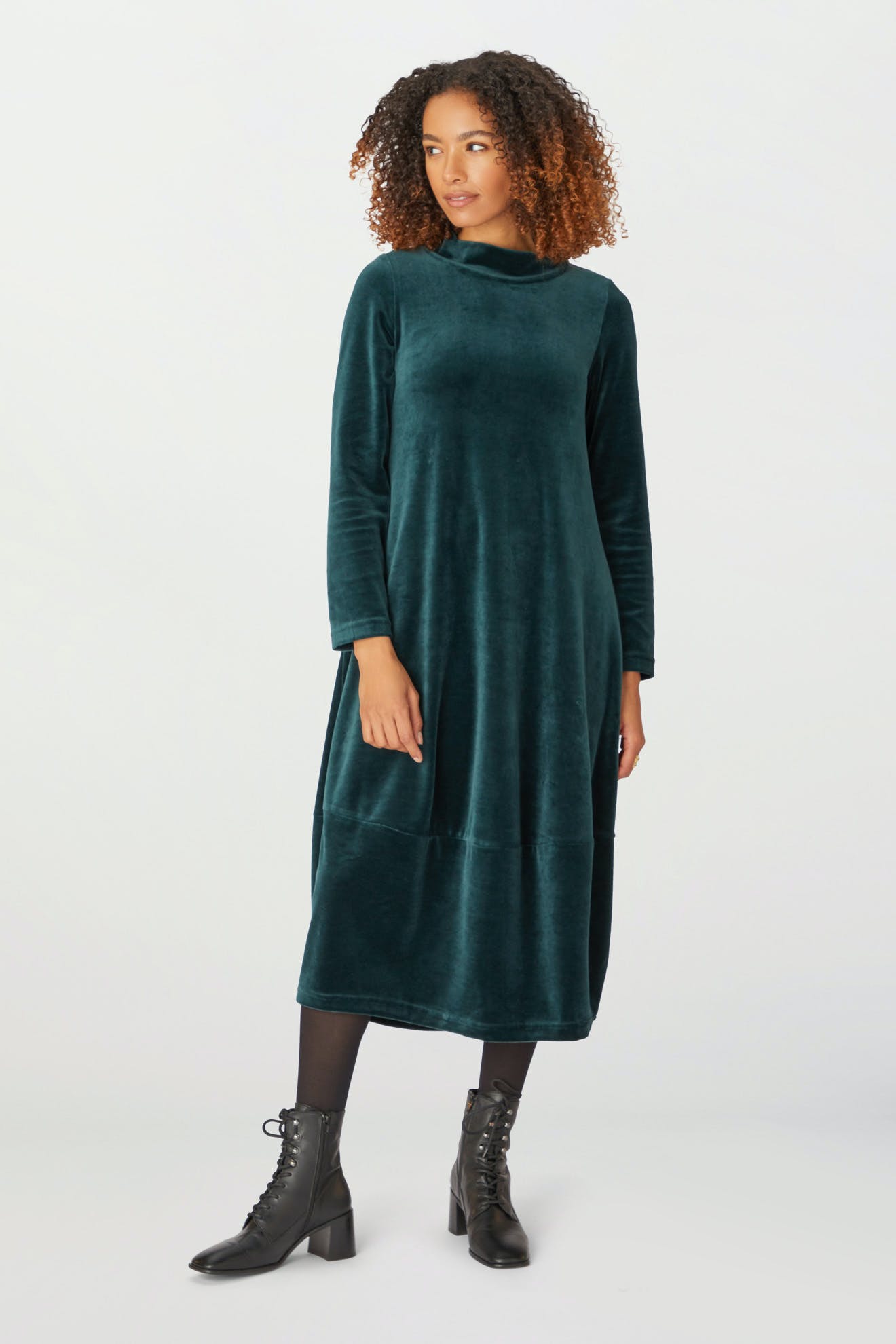A woman wearing a Velvet Jersey Bubble Dress in the holiday season.