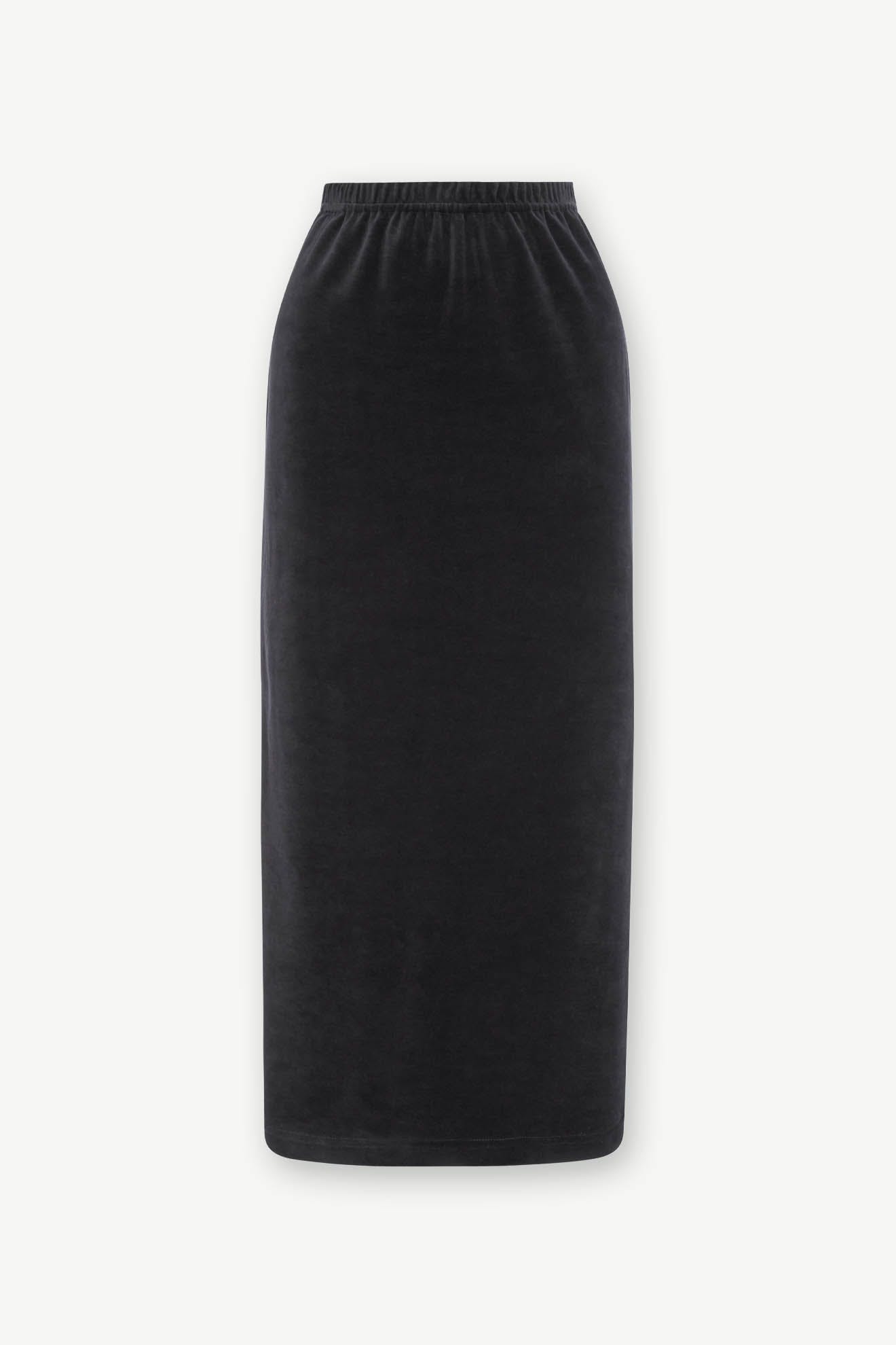The Velvet Jersey Tube Skirt is a black, high-waisted, knee-length velvet skirt with a classic silhouette and an elastic waistband.