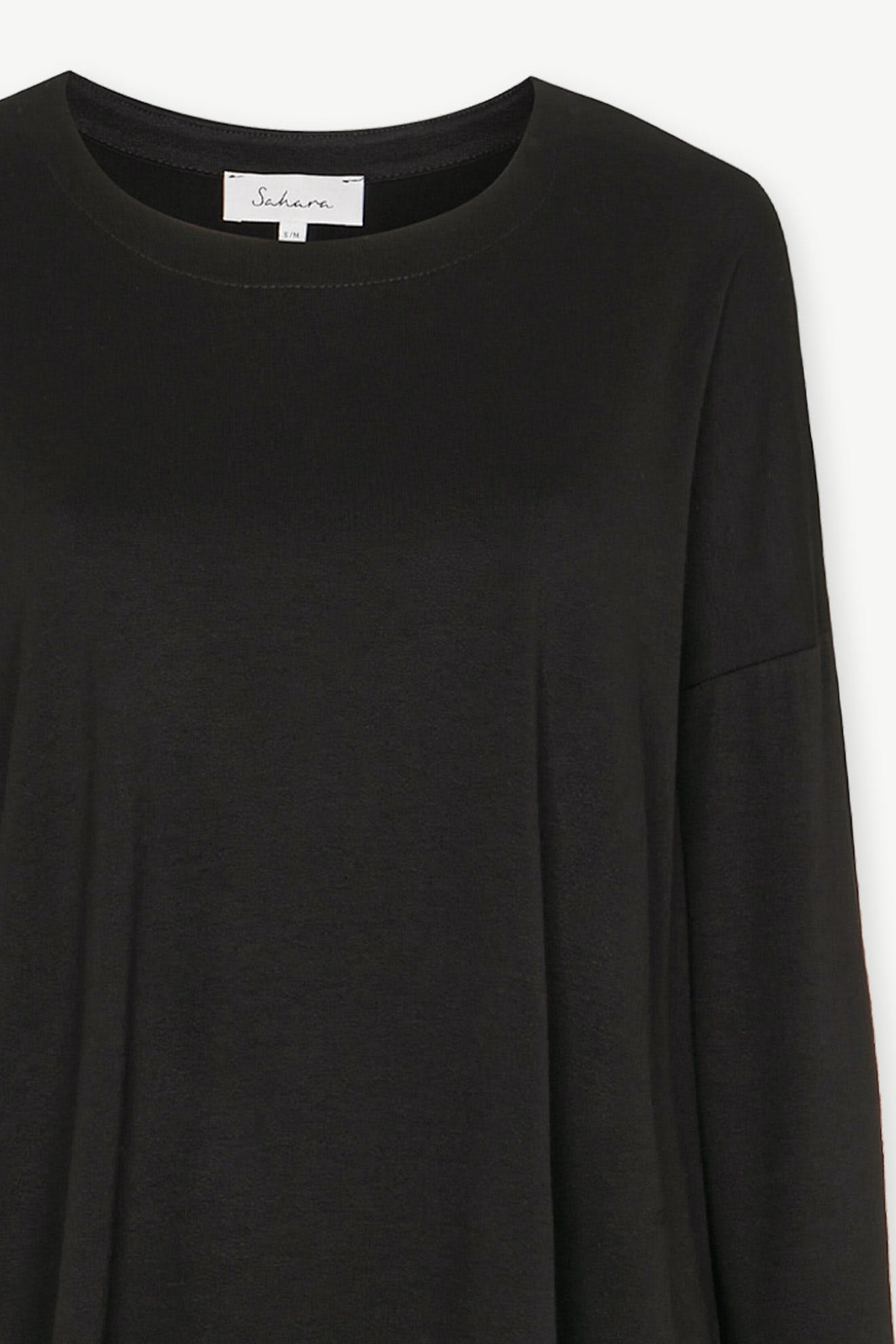 The Fluid Crepe Jersey Relaxed Top in black offers a long-sleeve design with a round neckline, creating an effortless silhouette.