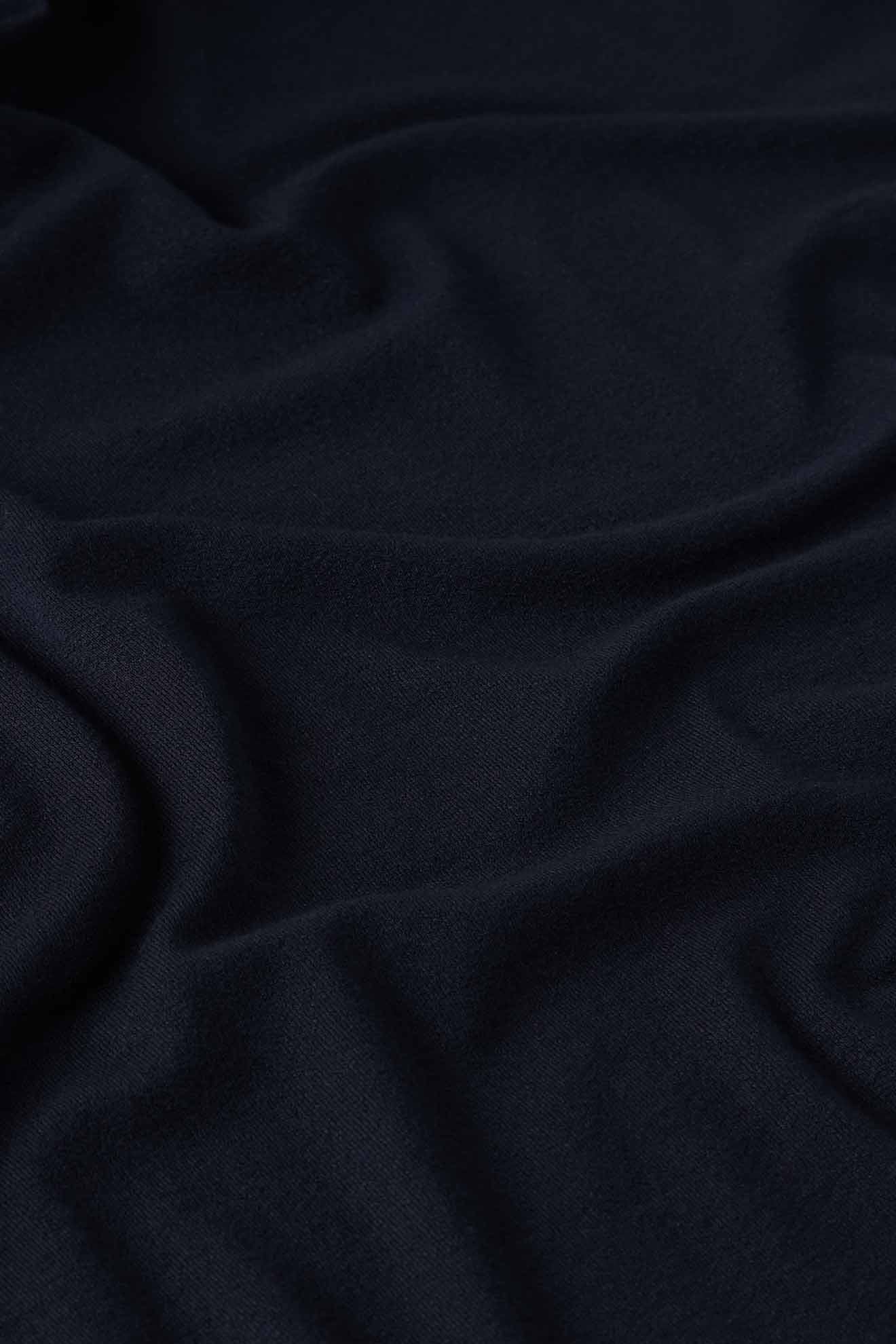 Close-up of the Fluid Crepe Jersey Relaxed Top, featuring dark, fluid crepe fabric with soft, flowing folds that create a smooth texture.