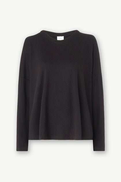 A soft black Jersey Easy Top with a ruffled hem.