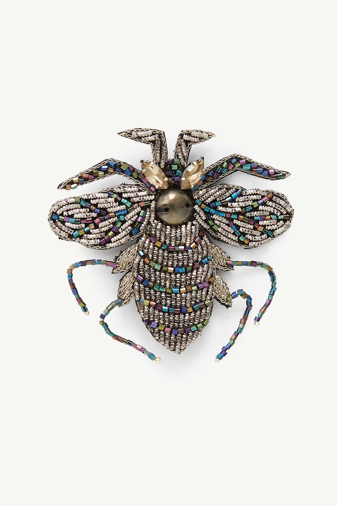 The Embroidered Bee Brooch features multicolored beads and silver details in a bee shape, displayed on a white background.
