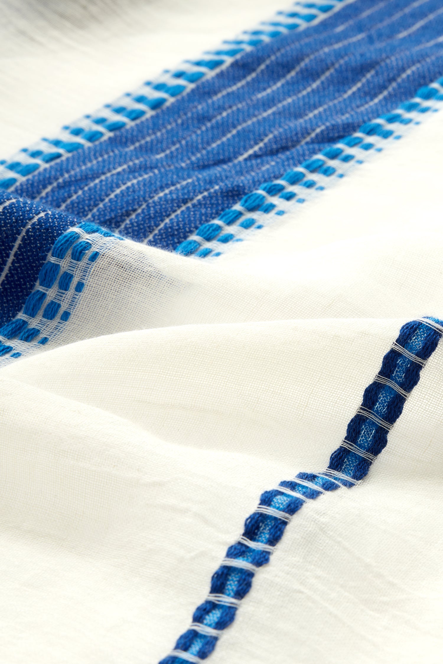 Close-up of an Embroidered Stripe Scarf with detailed stitching and texture visible.